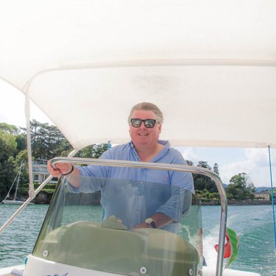 Gary at the helm of our powerboat for the day on Lake Como, Italy
