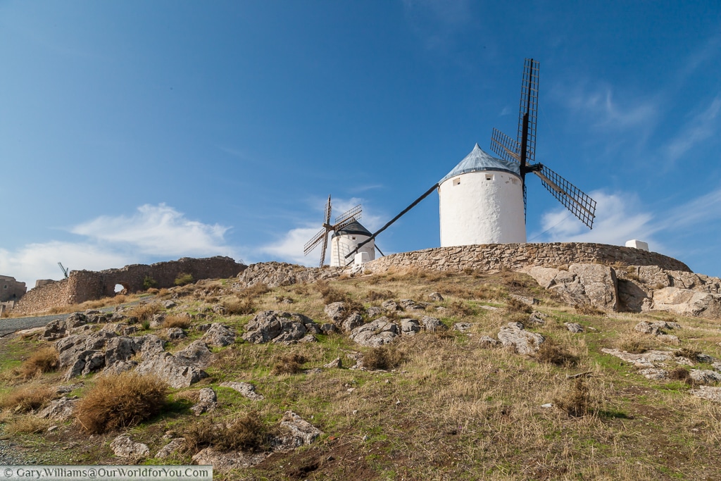 A pair of windmills pearched high-up the hill in Consuegra, La Mancha, Spain