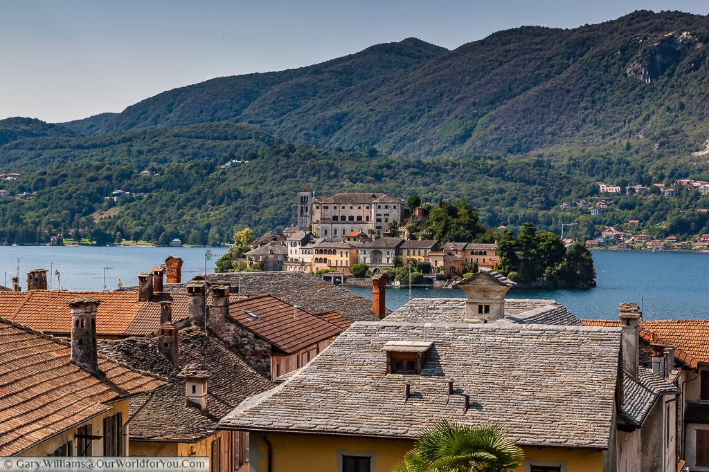 A view across the roof tops to Isola San Giulio from Orta San Giulio , Lake Orta, Italy