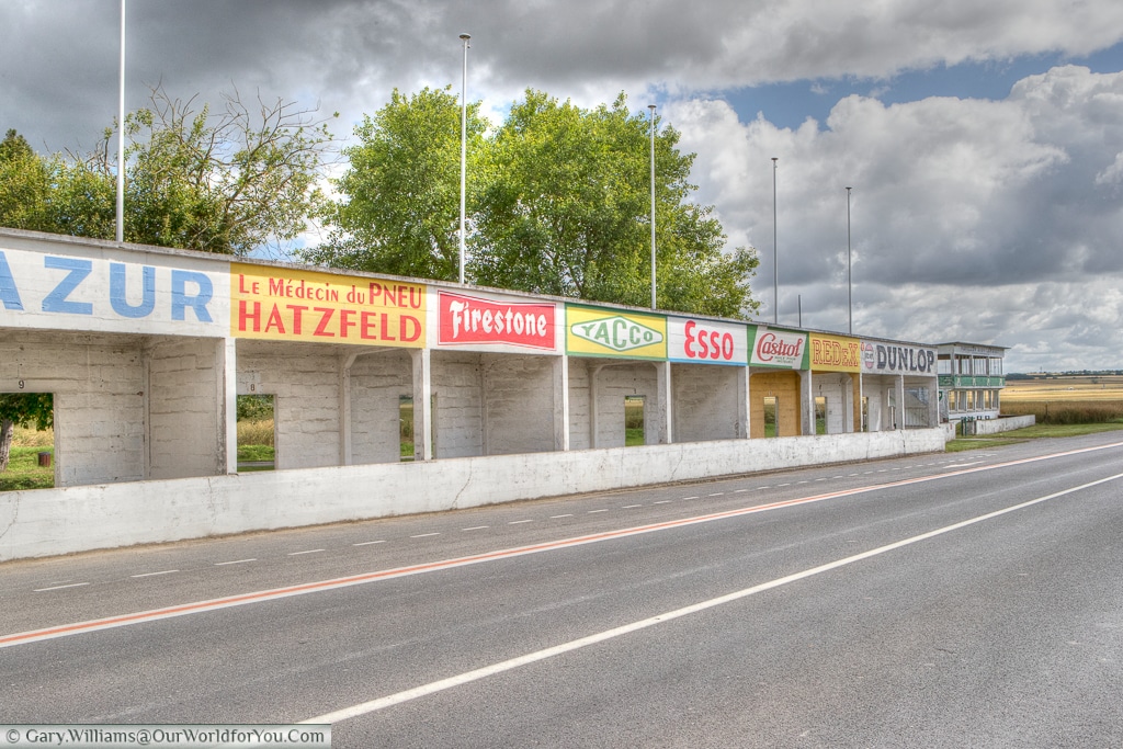 The bright coloured advertising hoardings above the pits of the Circuit Reims-Gueux, Reims, France