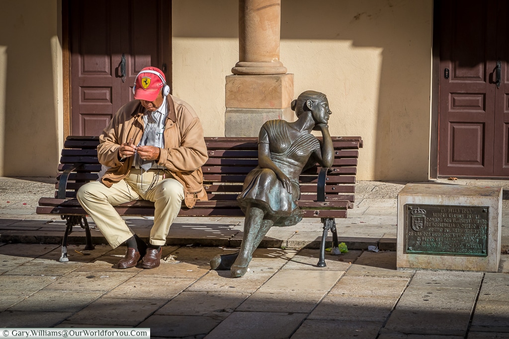 ‘La Bella Lola’ a beautiful lady sitting alone on a bench Oviedo, Spain
