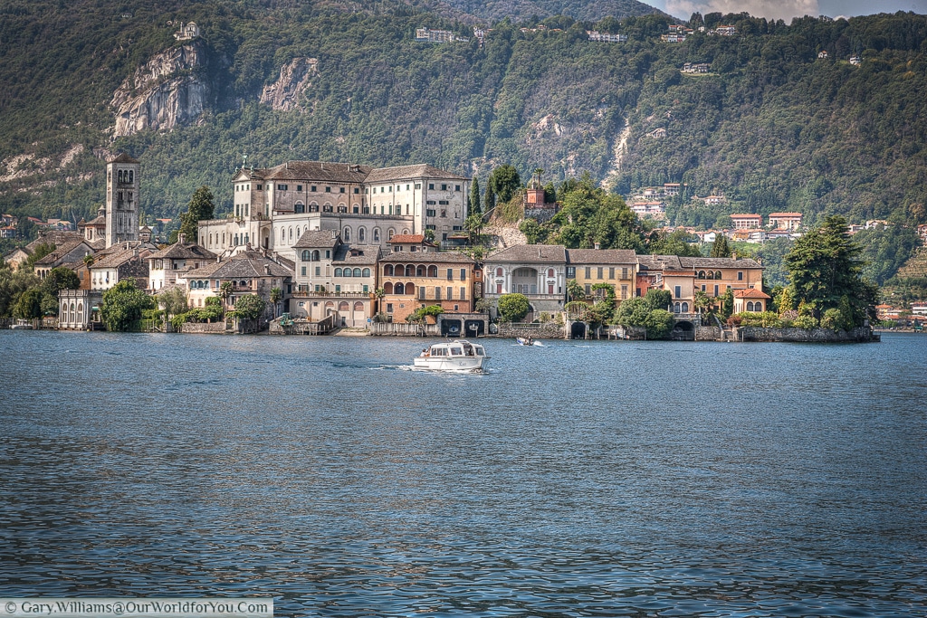 The Isola San Giulio, a boat returns to the jetty at Orta San Giulio, Lake Orta, Italy