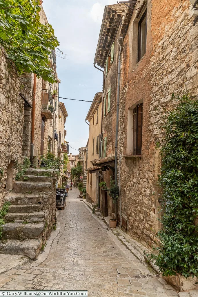 A small cobbled lane, lined on either side by old stone-built houses, wide enough for only a couple of people to pass.