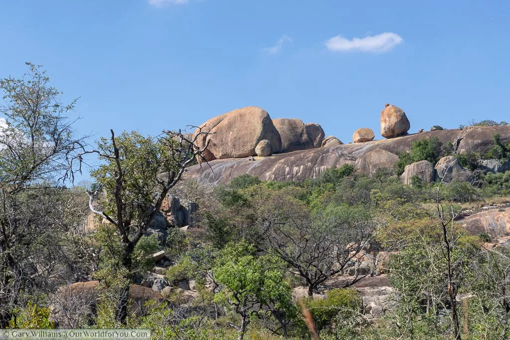 Worn granite boulders balanced high on the rock formation.