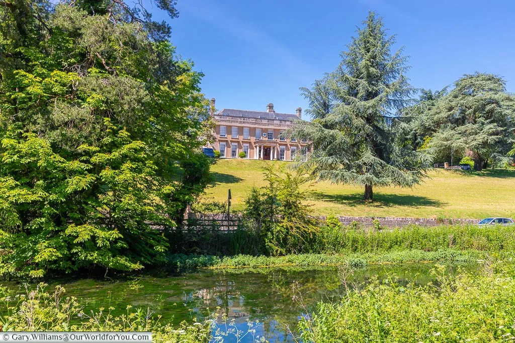 The Douces Manor building, as seen from the lake in Manor Park Country Park outside West Malling
