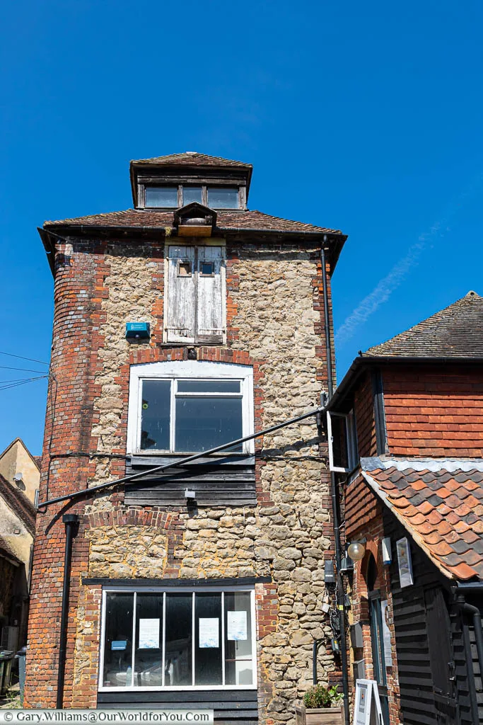 An old red brick and Kent ragstone tower is hidden in Mill yard in West Malling, Kent