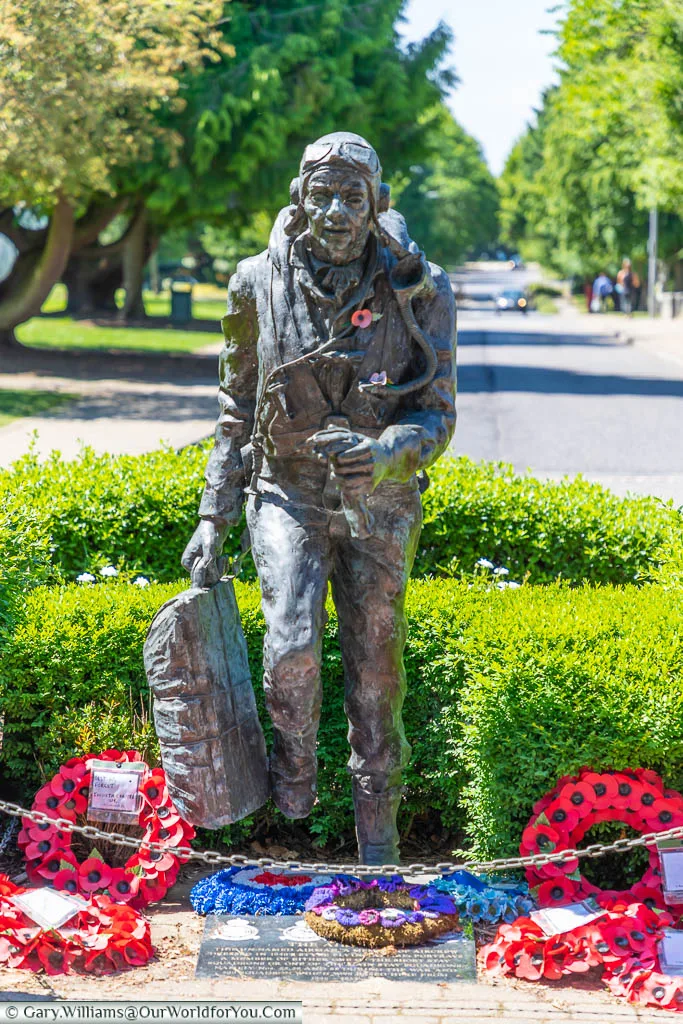 A bronze statue memorial, titled 'running Airman', in the centre of King's Hill, formerly RAF West Malling