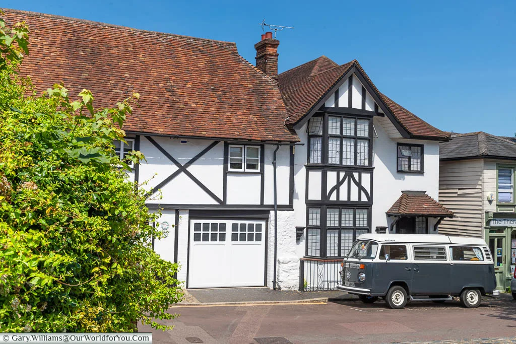 A VW Camper van in front of a Tudor period timber-framed home in King Street, West Malling, Kent