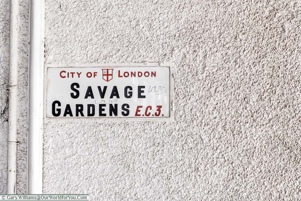 The City of London Street sign for Savage Gardens in the EC3 quarter of the square mile. The street sign has a red font for the City of London & EC3, and the street name is in a black font, all on a white background.