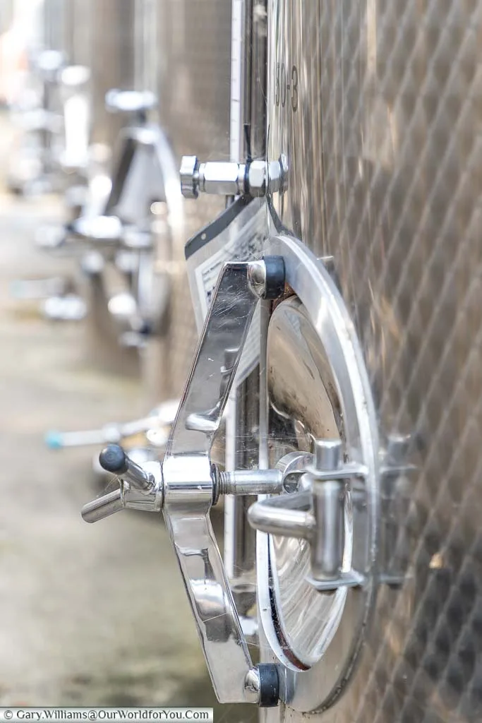 A close-up shot of one of the large stainless steel wine vats for holding the pressed grape juice and it takes it's a journey to becoming a Chapel Down wine.