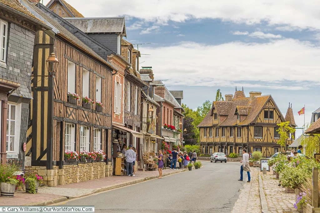 The main route through Beuvron-en-Auge, on Normandy's Route de Cidre, with half-timbered houses lining one side.