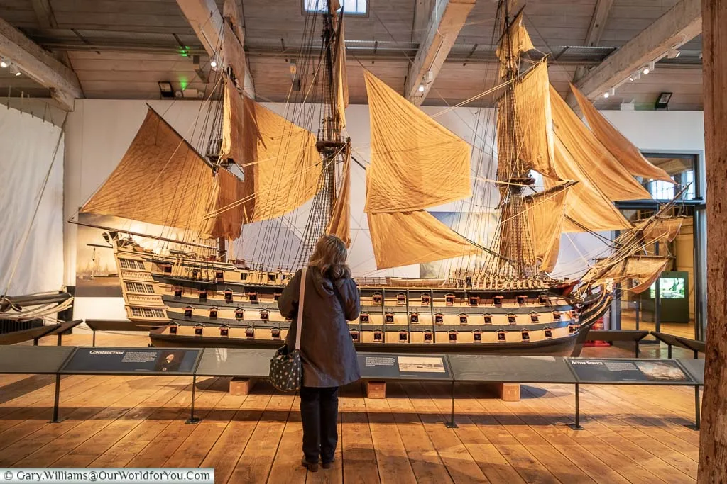 Janis standing in front of the giant model of HMS Victory in the Command of the Oceans exhibition at the Historic Dockyard Chatham