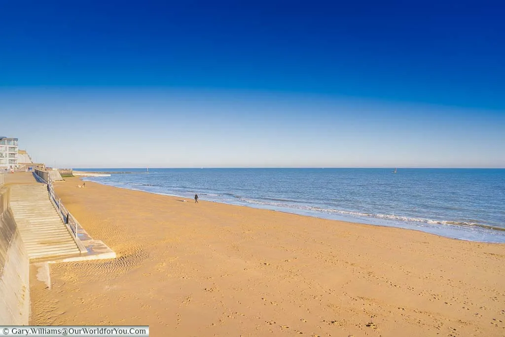 The clear golden sands of Ramsgate's beach under a deep blue sky.