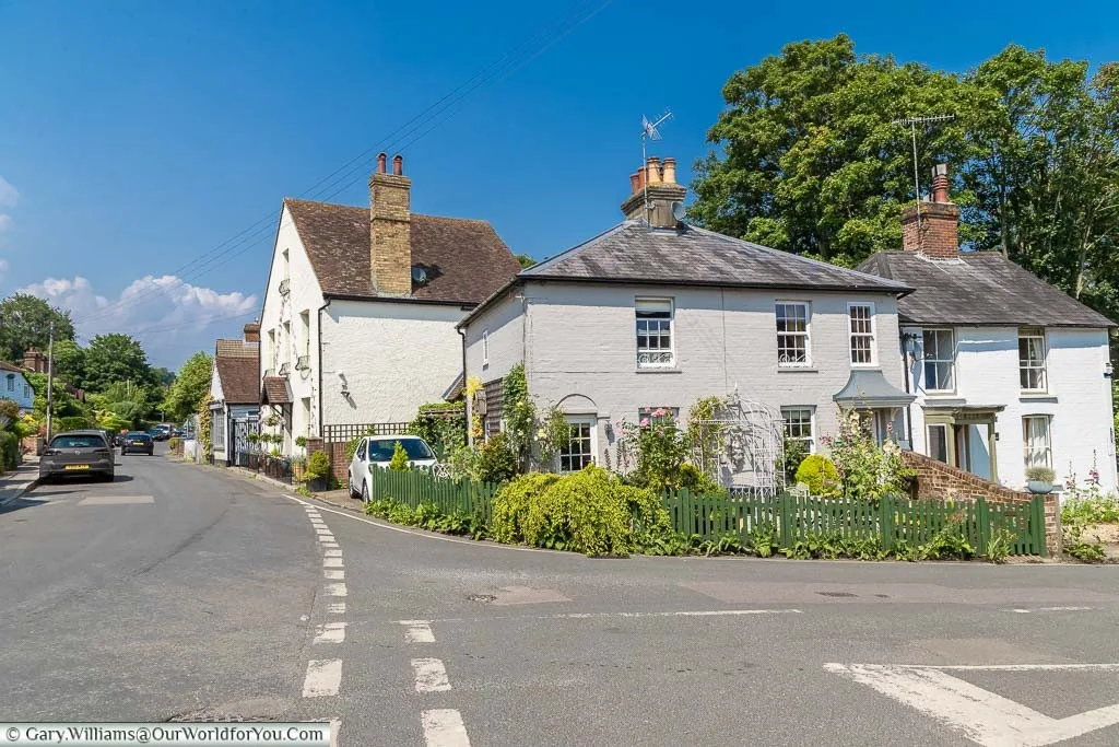 White weather-boarded cottages at the junction of the High Street and Church Street in Shoreham, Kent