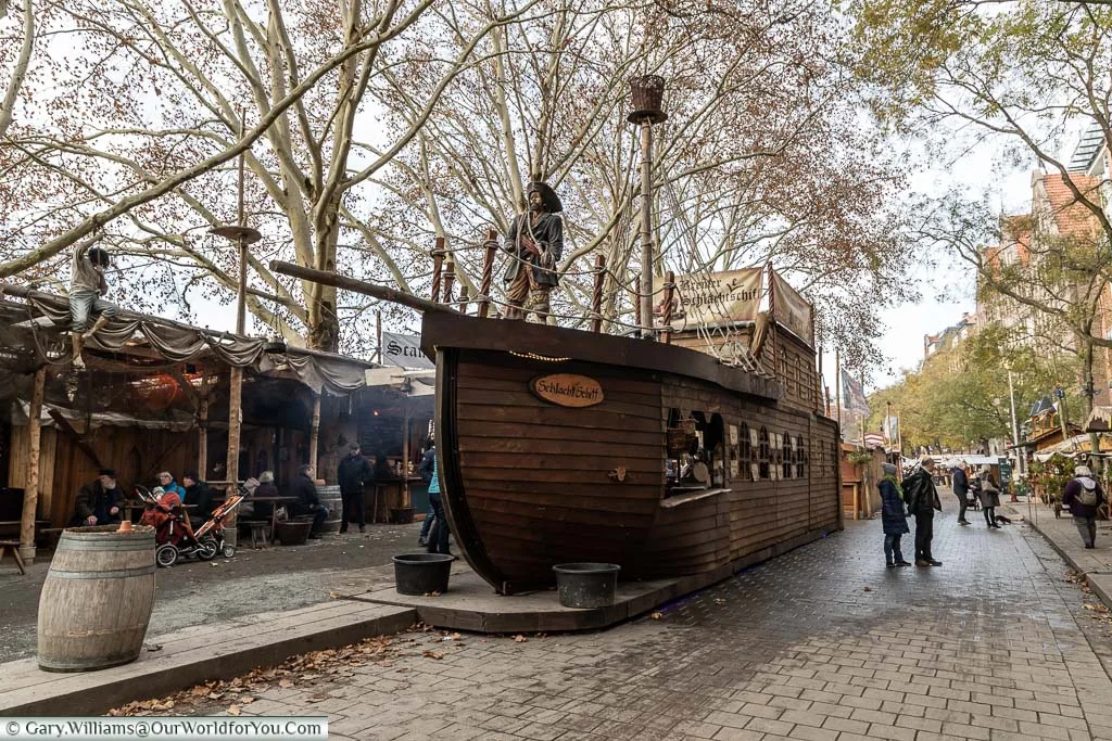 A wooden pirate ship in the centre of the Schlachtezauber market on the quayside in Bremen that is actually a food stall
