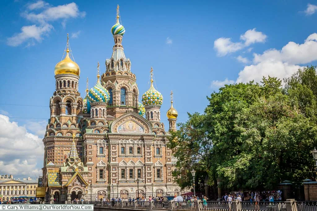 The wonderfully ornate Church of the Saviour on spilled blood alongside the canal banks in Saint Petersburg Russia. It topped by brightly coloured onion domes of various styles.