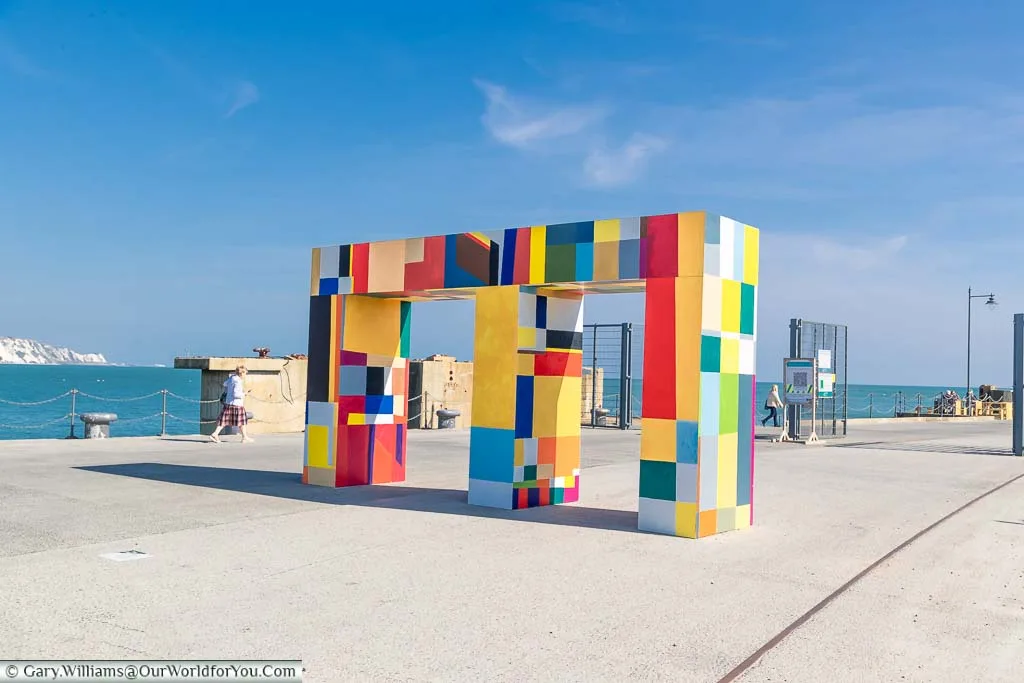 A brightly coloured gateway on the harbour arm in Folkestone by Atta Kwami