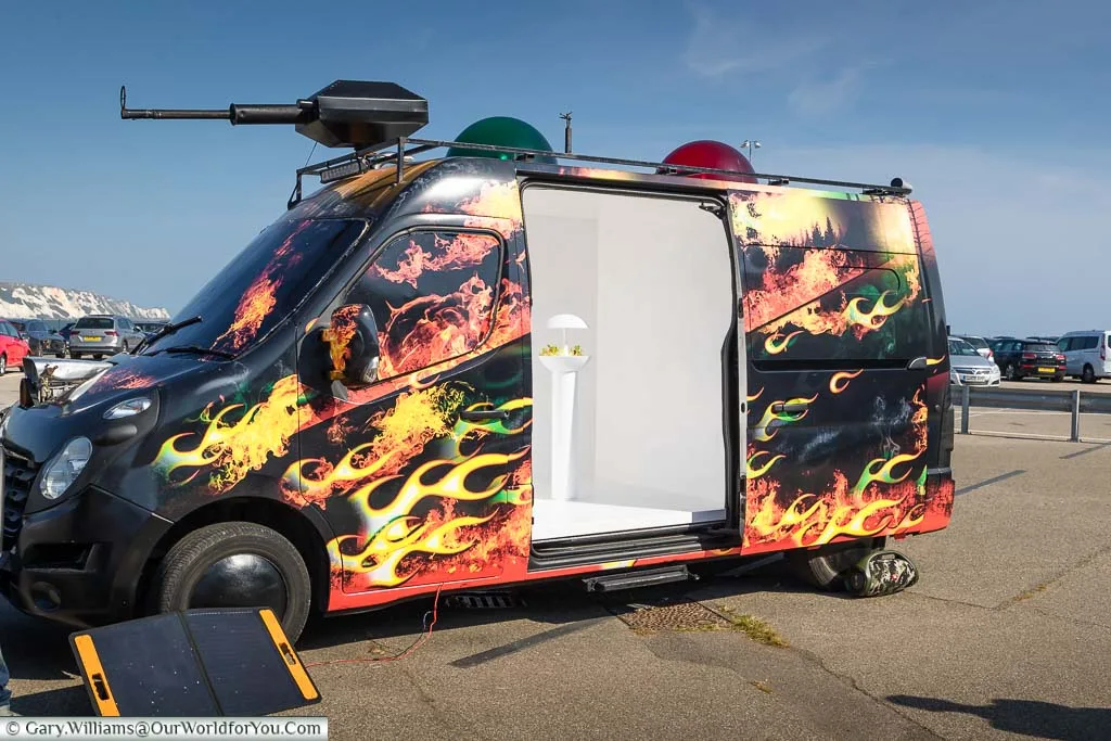 A customed van emblazoned with Climate Emergency Services parked in the Harbour Arm of Folkestone