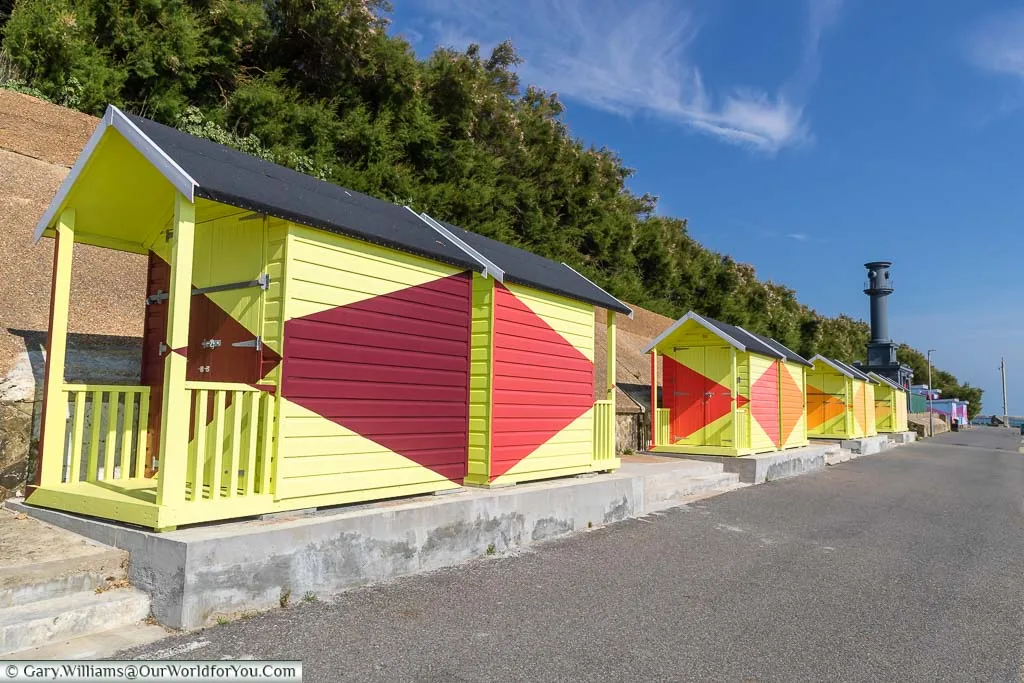 Brightly coloured beach huts on Folkestone's coastal path as part of an art installation
