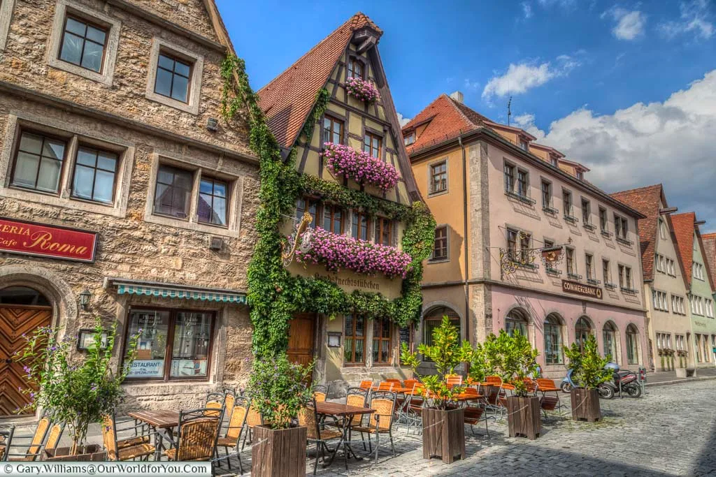 Traditional Barbarian half-timbered buildings decorated with flowering hanging baskets and Ivy growing over the buildings.