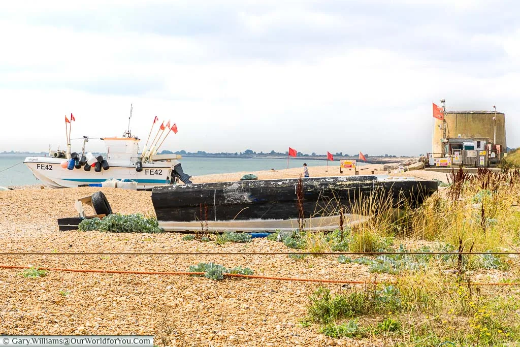 Fishing boats on the beach at Hythe with the Martello Towers in the background