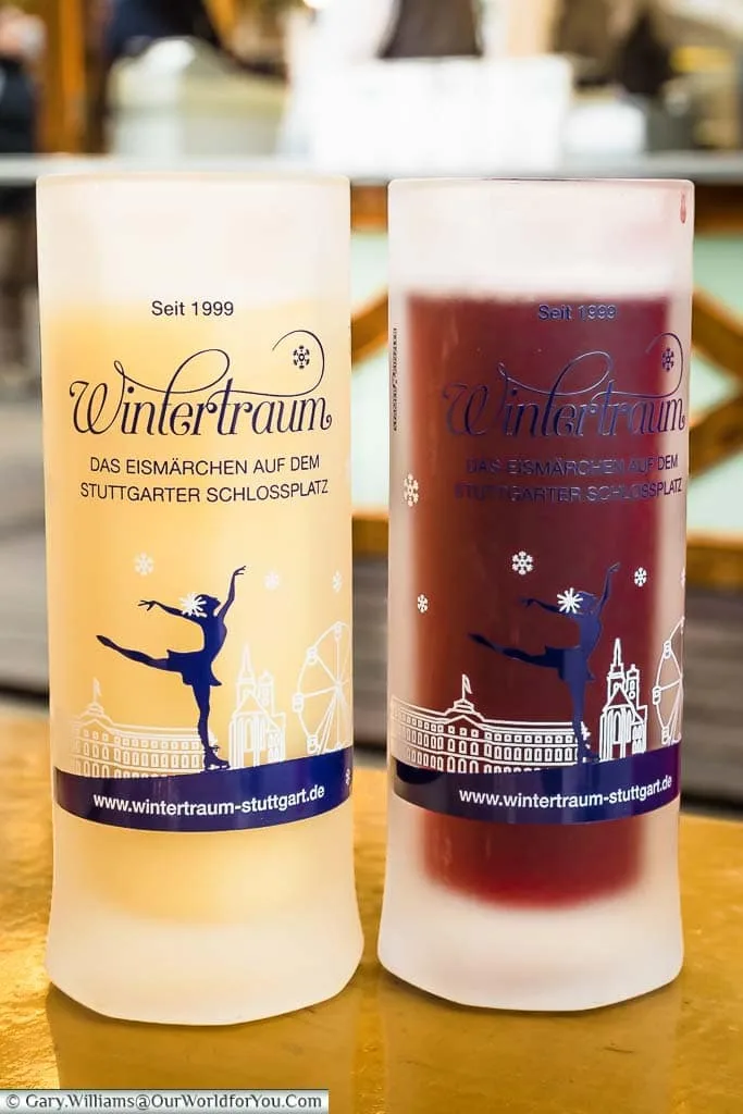Two long thin glass tankards; one with glühwein, the other with eggnog from Stuttgart's Wintertraum Christmas Market.