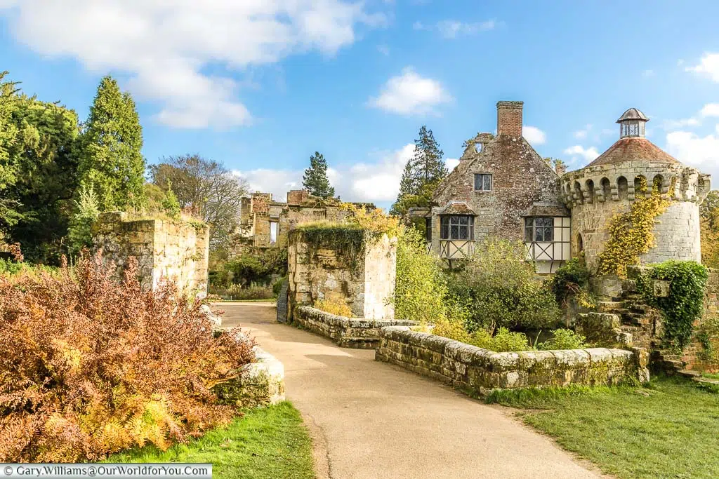 The path leading through the ruins of the outer walls of Scotney Castle on a bright autumnal day
