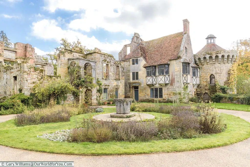 A small circular garden in front of the ruins of Scotney Castle