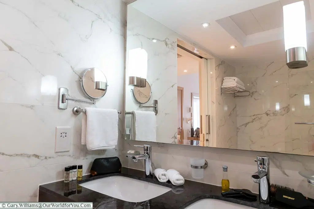 Our stylish, modern bathroom at Olympic Lagoon Resort Paphos features a mix of white marble & black granite with chrome features.