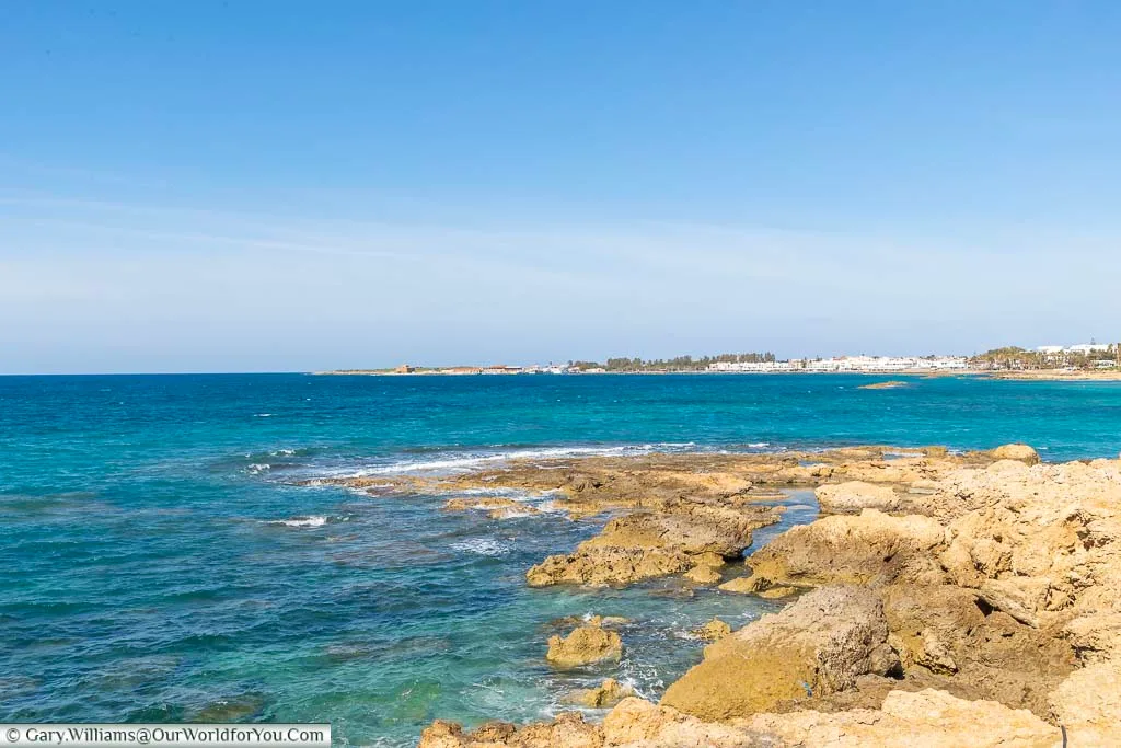 The clear blue waters of the Mediterranean sea from the coastal path outside the Olympic Lagoon Resort Paphos looking towards Paphos Harbour in Cyprus