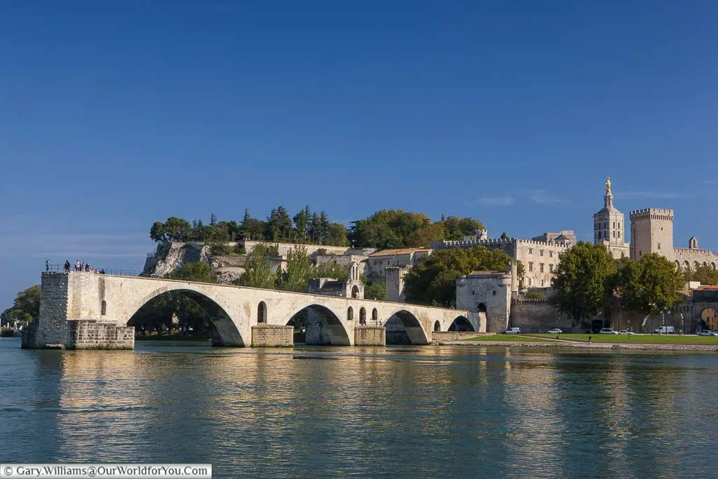 A view across the Rhône river to the remains of the Pont d’Avignon and the Palais des Papes in the background.