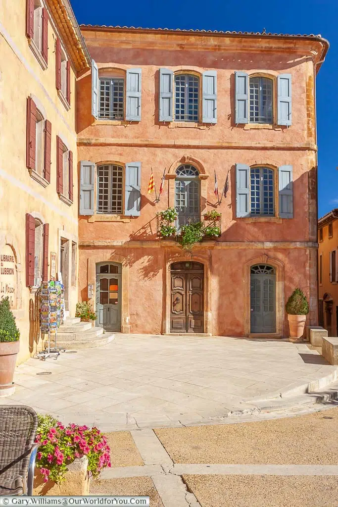 Typical provencal homes in pretty pastel colours with shutters at the windows in the hillside town of Luberon