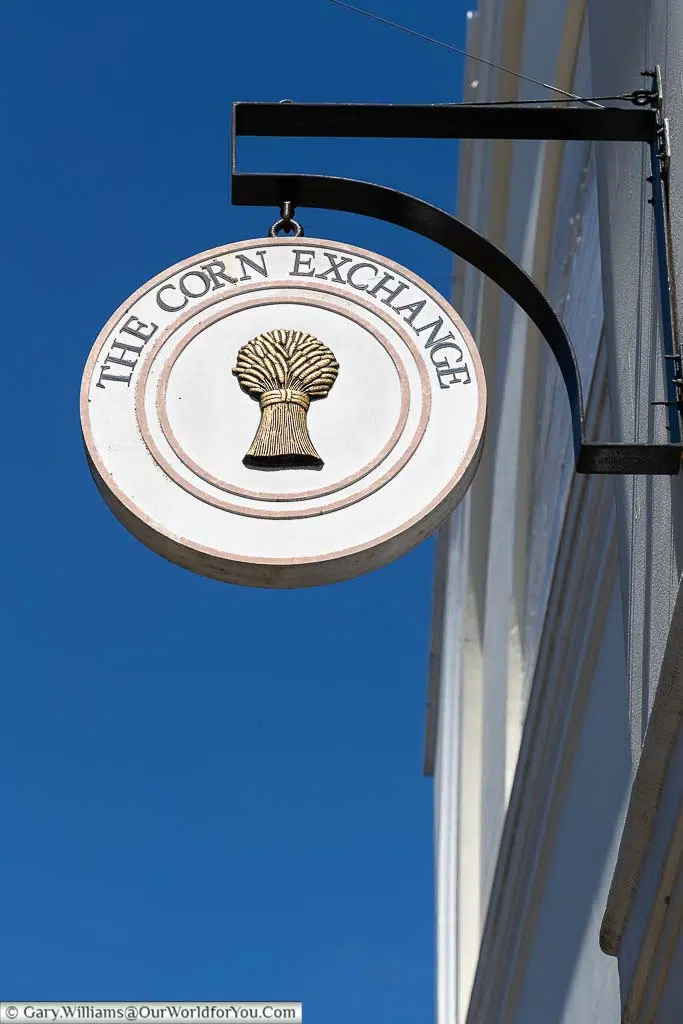 The corn exchange sign, set against a deep blue sky, hanging off the old corn exchange in maidstone