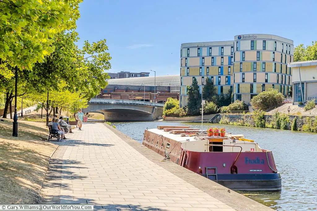 A wide beam canal boat moored up on the banks of the River Medway in the heart of Maidstone