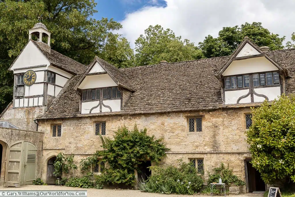 Tudor buildings line one side of the stable courtyard at lacock abbey in wiltshire