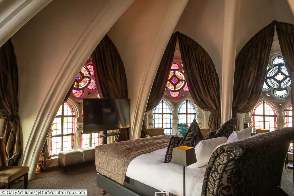 Our extraordinary room in Hotel Martin’s Patershof in the upper reaches of the Apse of the former church with authentic stained glass windows.