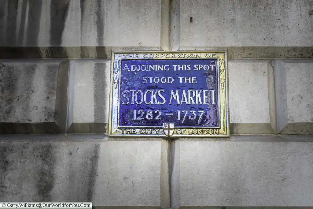 A blue enamel plaque recognising the spot there the ancient Stocks Market stood