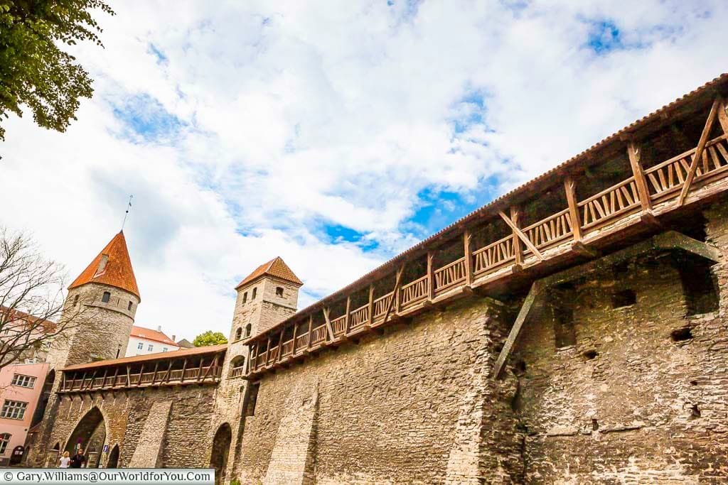 The high stone medieval walls surround Tallinn's old town, complete with covered walkway and watchtowers.