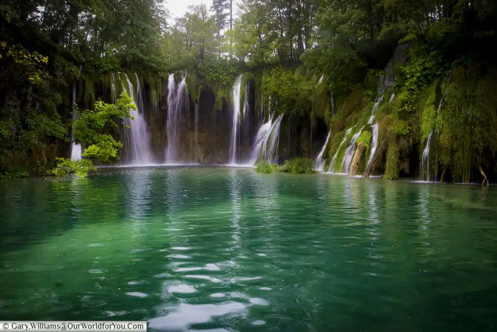 Looking down on numerous pools, nestled in chalk ravine, linked by walkways, as they flow down the valley creating multiple waterfalls.