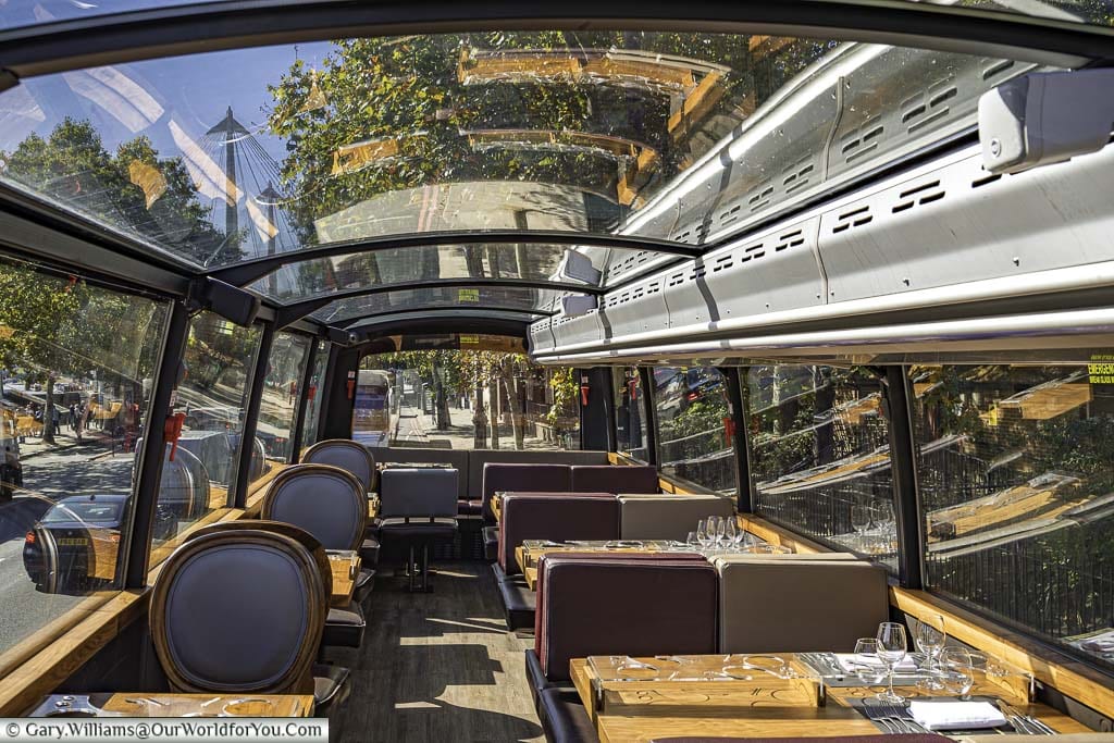 Inside the upper deck of the Bustronome tour bus with its panoramic glass roof.