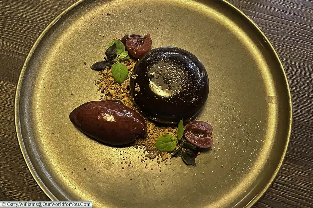 A mirror-glazed bombe of Black Forest Gateaux, served with a quenelle of cherry ice cream at the forge restaurant in the hotel indigo chester