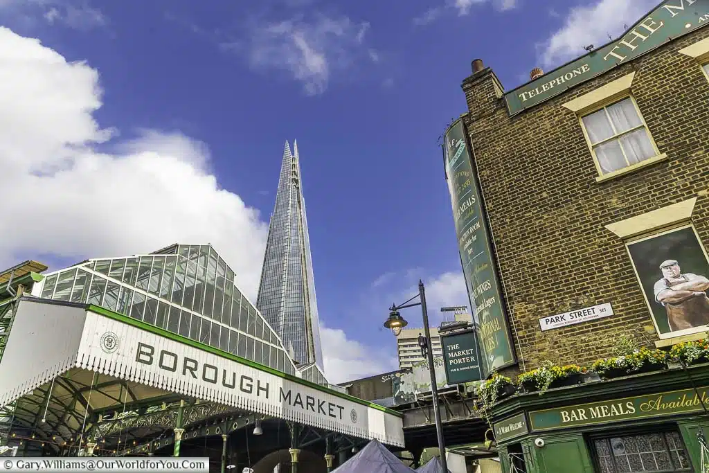 One entrance to London's Borough Market next the Market Porter pub and The Shard in the background