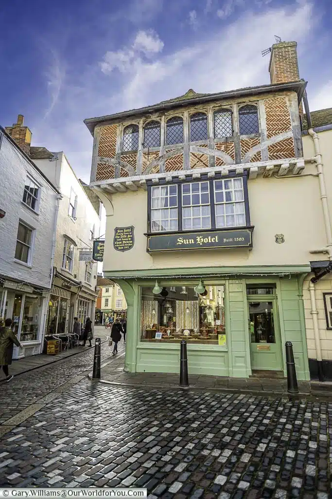 The Sun Inn, a 15th-century Tudor building on a cobbled street in Canterbury