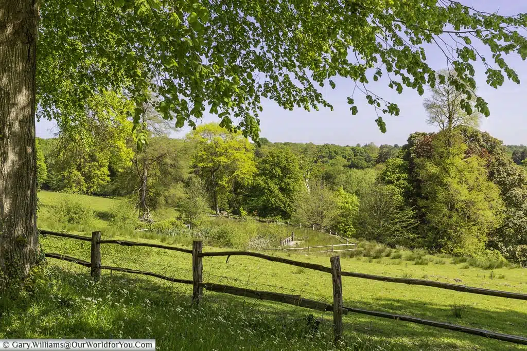 A view of the west sussex countryside from a pathway in the national trusts nymans house and gardens