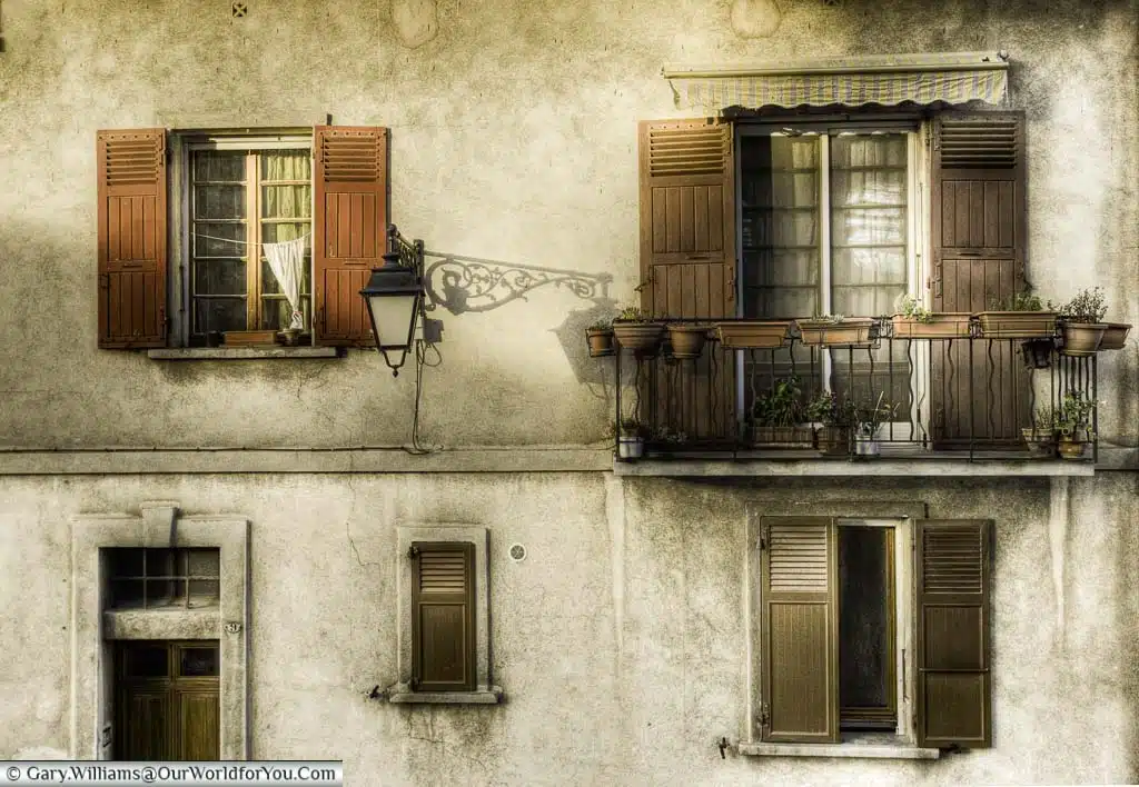 Earthy ochre tones of a series of shuttered windows in a home in Arles, Provence