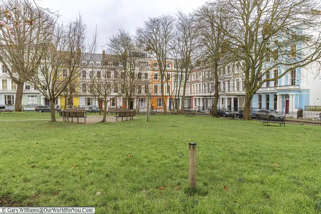 A public garden in Primerose Hill surrounded by colourful Georgian townhouses.