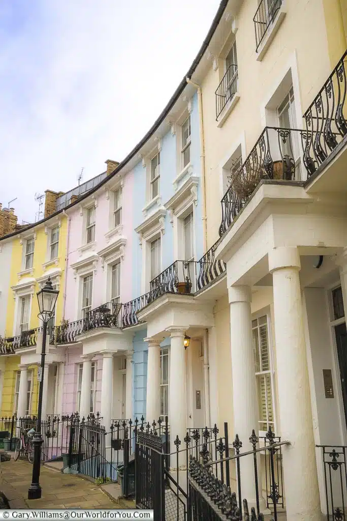 A row of pastel-coloured Georgian homes in along Chalcot Crescent, Primrose Hill