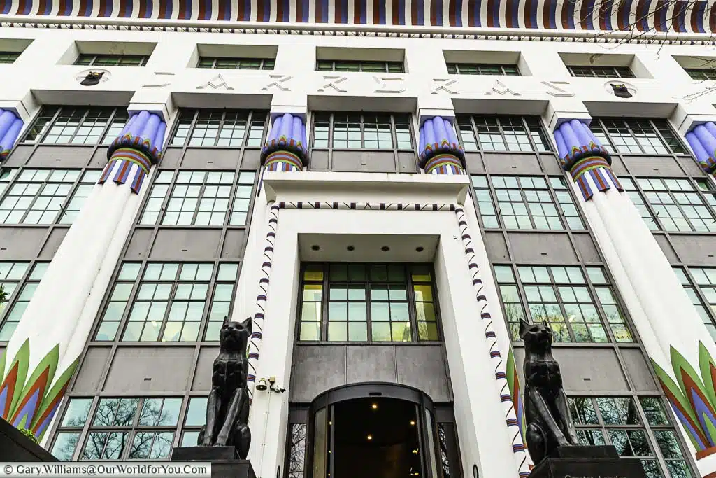 The Art Deco facade to London House, formerly the Carreras Cigarette Factory, with its two Egyptian bronze cats standing guard at the front of the building.
