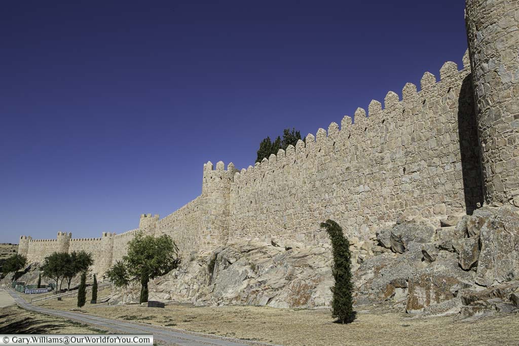 The exterior of old city walls of Ávila with 6 of its famous towers on show.