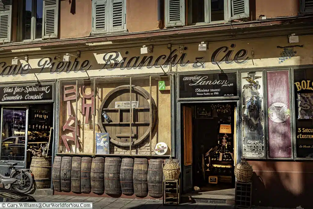 the exterior of a historic wine merchants in the back streets of nice in the south of france